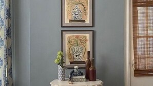 A room with a grey wall, a framed artwork above a small table, and a door with a window blind. - The Stinson Suite, Jenny's Downtown Hideaway Bed and Breakfast-The Stinson Suite (Laurel)
