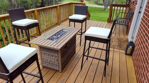 A deck with a glass-top table, four chairs, and a fire feature. - Private Guest Suite 2BR/1BA  in Haysi near Flannagan Dam (Haysi)