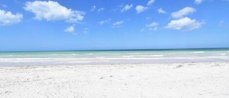 Plage privée, sable blanc, chaises longues, serviettes de plage