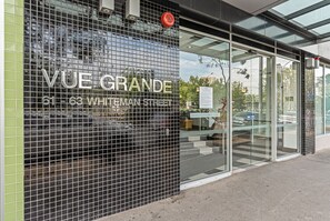 VUE GRANDE hotel features a modern glass entrance and a tiled exterior.
