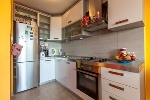 Enjoy cooking in this well-equipped kitchen with a gas stove, refrigerator, and microwave.