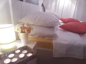 Cozy retreat with a bed, vase, and lamp, perfect for a restful stay.