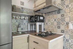 A kitchen with a microwave on the counter, a sink, and a cabinet. - Holiday Home 'Tiny House La Loma' with Private Terrace and Private Garden (Barbate)