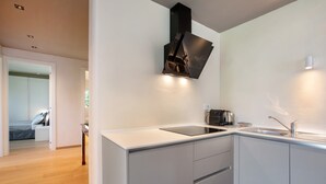 A modern kitchen with a built-in stove, a sink, and a countertop.