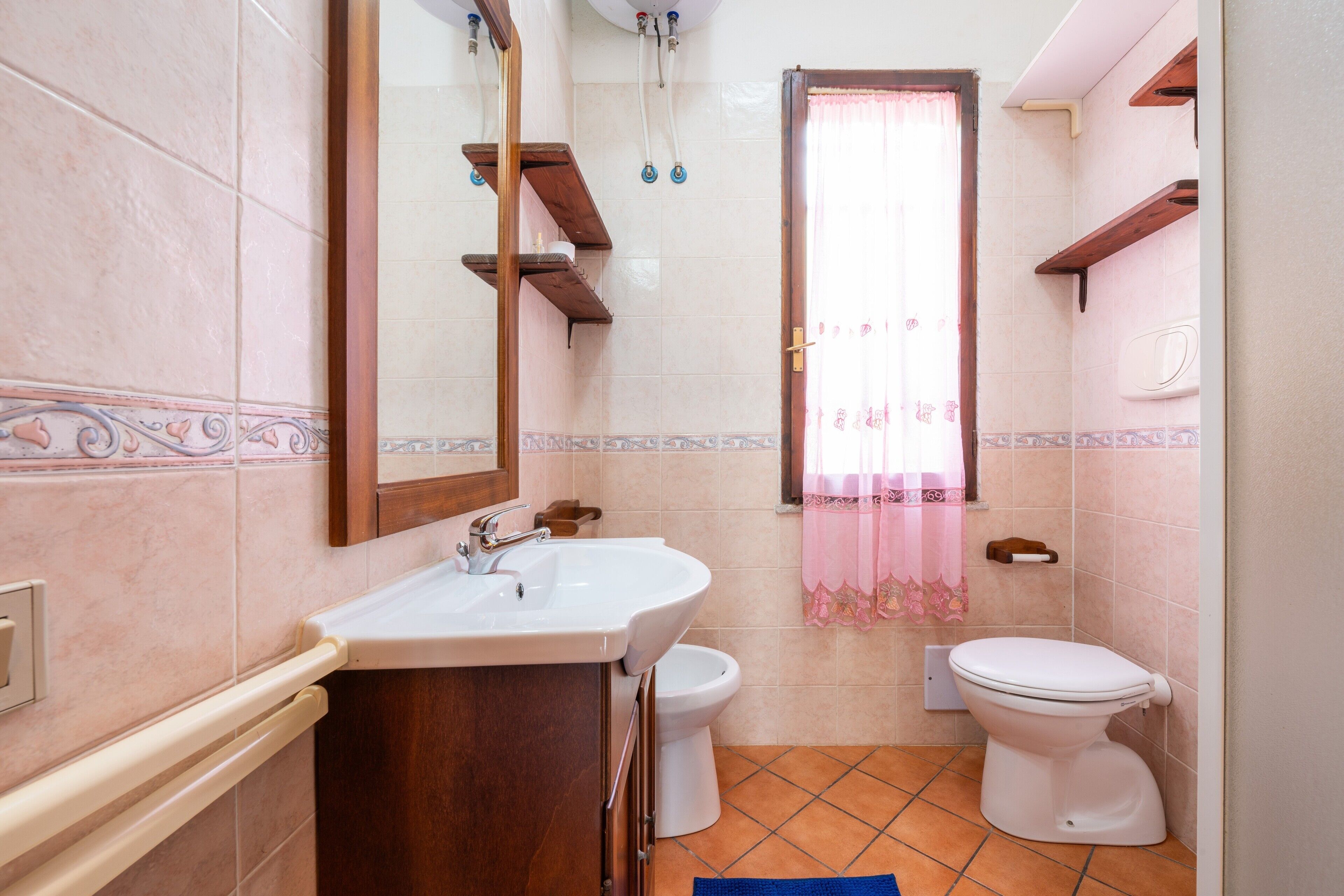 A bathroom with a sink, toilet, and shower.
