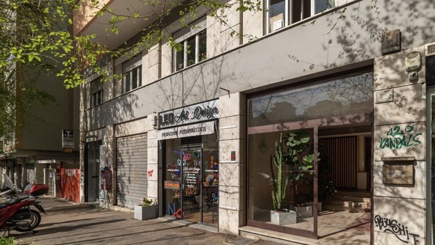 A building with a storefront named 'LED Art Design' featuring glass doors and windows. - GuestHost - 4 Winds Holiday Rental (Roma)