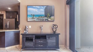A modern kitchen with dark cabinetry, a built-in refrigerator, and a countertop. - Las Palomas Phase I Topaz 202 Exceptional OceanView 1BR 1BA Unit. (Puerto Peñasco)