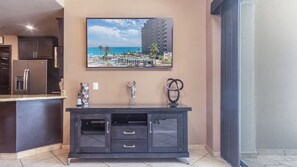 A modern kitchen with dark cabinetry, a built-in refrigerator, and a countertop. - Las Palomas Phase I Topaz 202 Exceptional OceanView 1BR 1BA Unit. (Puerto Peñasco)