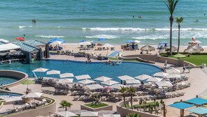 A resort with a large pool area, beach access, and lounge chairs. - Las Palomas Phase I Rubi 901 Exceptional OceanView 3BR 3BA Unit (Puerto Peñasco)