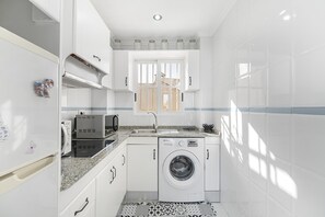 Fridge, microwave, coffee/tea maker, cookware/dishes/utensils