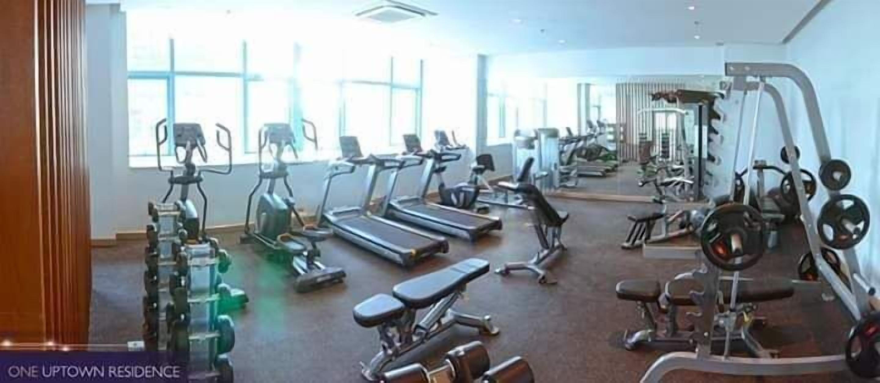 A gym with treadmills, stationary bikes, and weight machines.