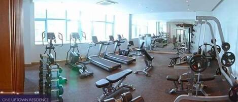 A gym with treadmills, stationary bikes, and weight machines.
