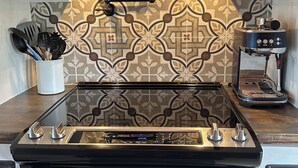 A kitchen with a modern stove, oven, and coffee maker. - Gorgeous New Cabin with 70Acres!Trails, Waterfalls and Amazing Rock Formations! (Cub Run)