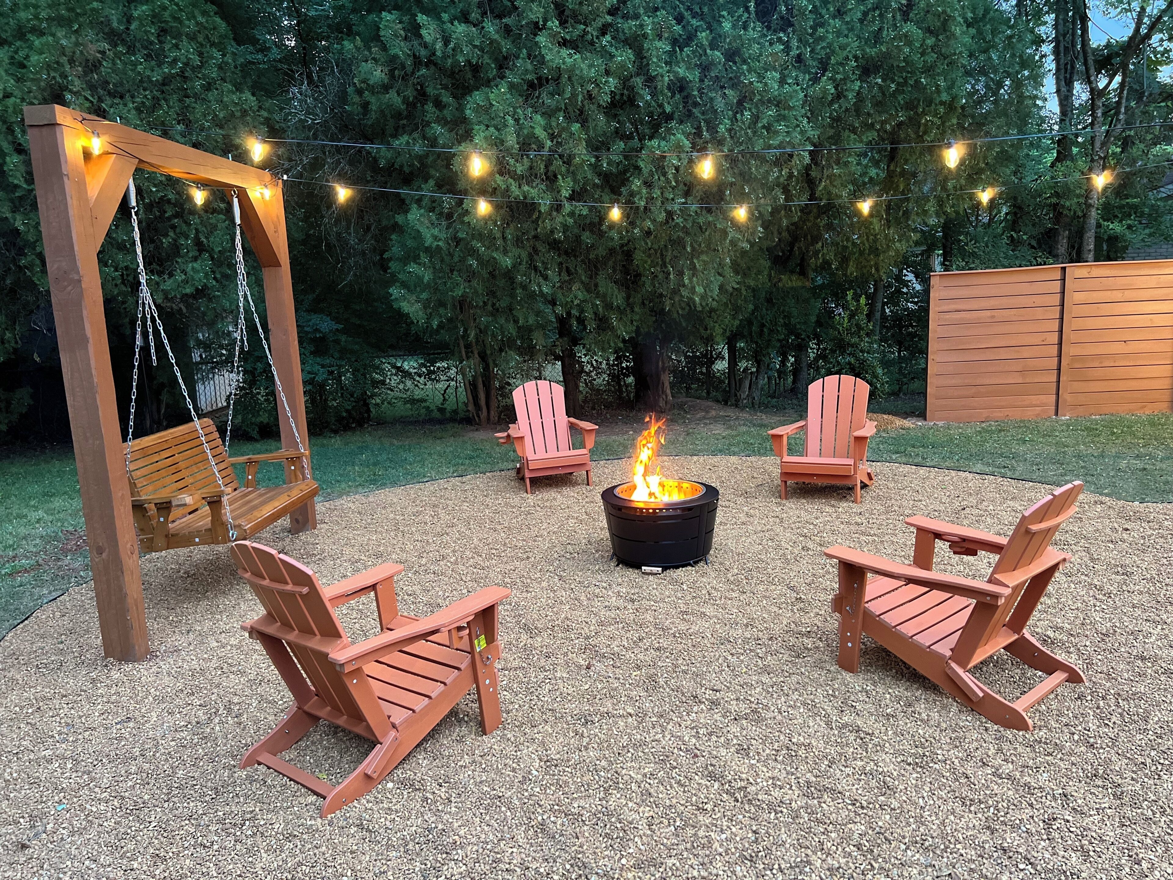 Cozy Huntsville Retreat: Firepit, swing, and string lights for a perfect evening