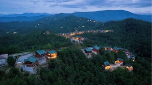 A resort with multiple buildings surrounded by dense forest, featuring a winding road connecting them. - Fabulous Mountain views,4-bedroom cabin, Indoor Heated Pool, Hot Tub, Media Room (Sevierville)