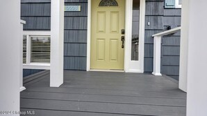 A house with a yellow door, a mailbox, and a number sign '2225'. - 3 Bedroom Beach Oasis - HOT TUB - Pet Friendly (Seaside)