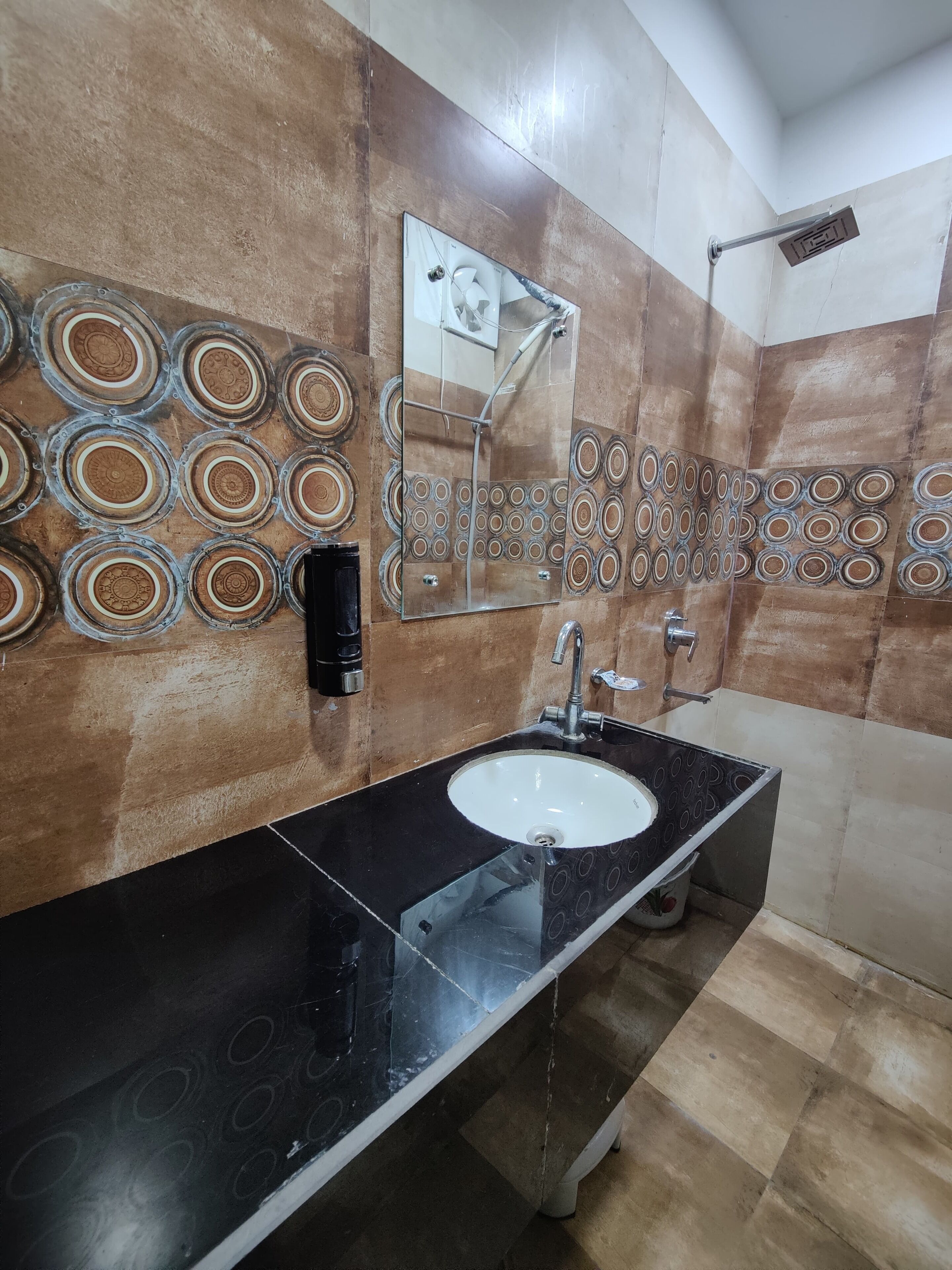 A bathroom with a black sink, a mirror, and a shower.