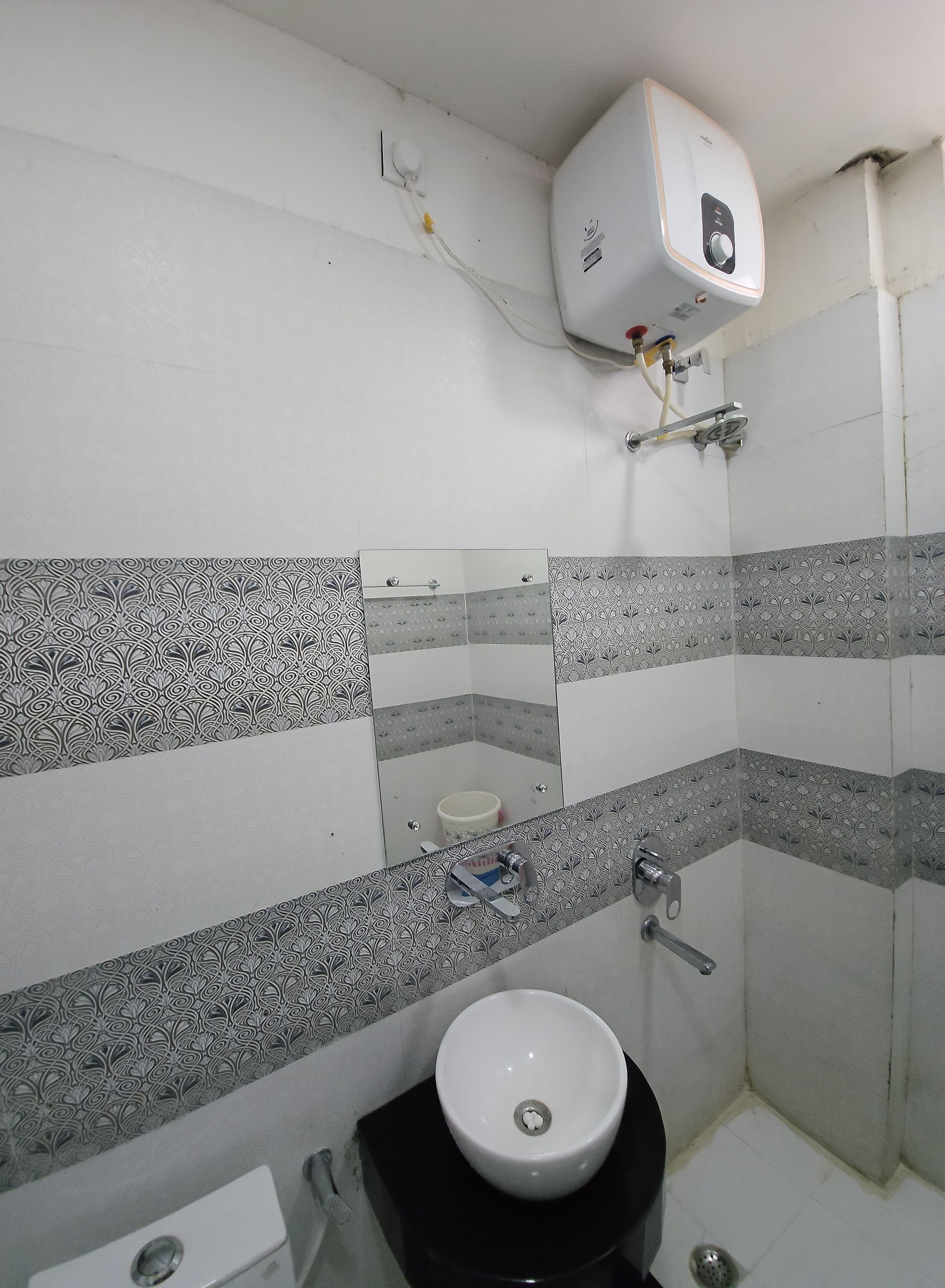 A bathroom with a toilet, sink, and shower.