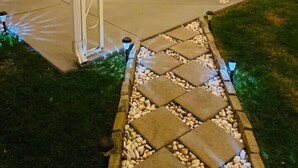 A house with a covered porch, a staircase, and a stone pathway leading to the entrance. - Enchanting 2-bedroom house across ISU in Pocatello (Pocatello)