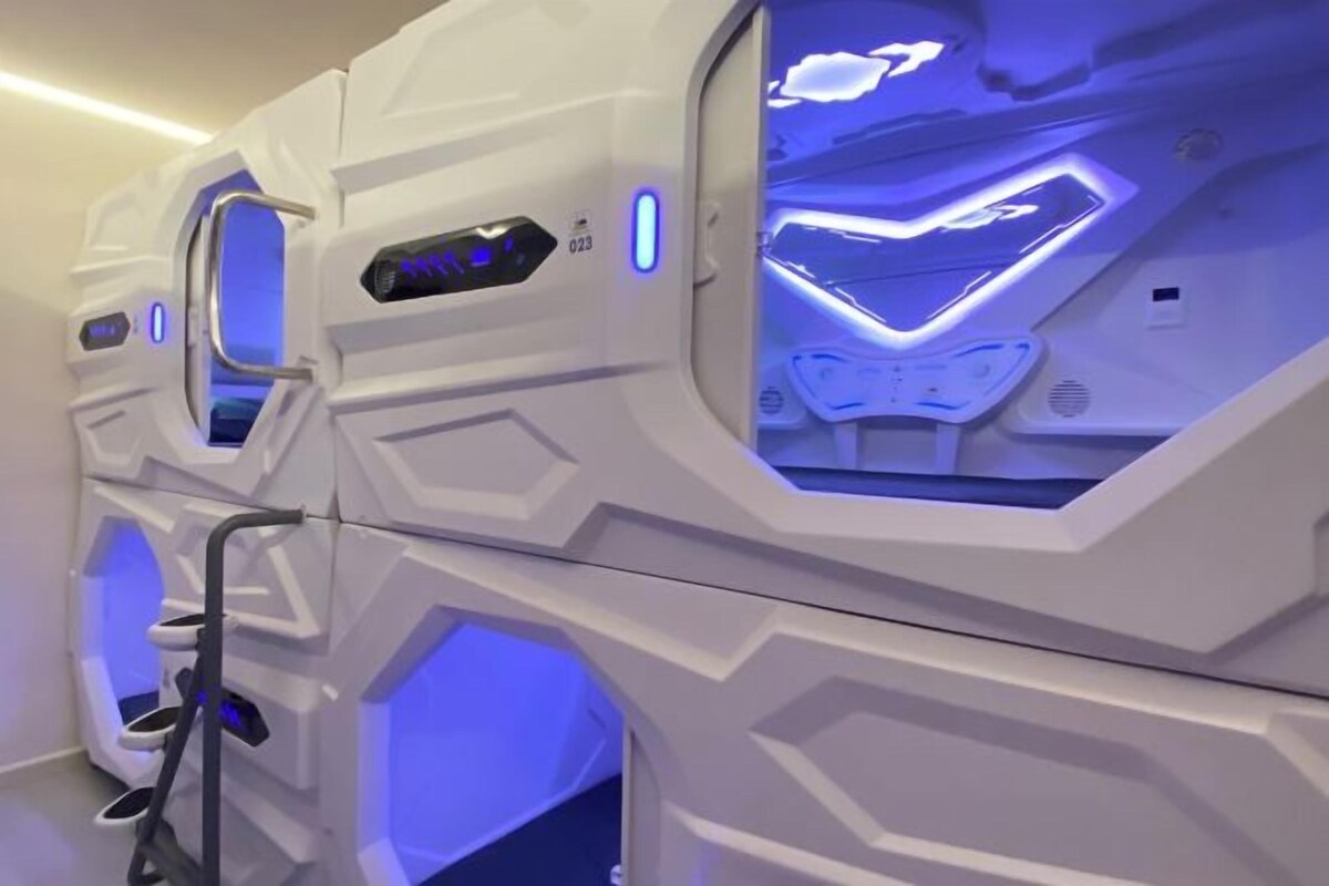 A row of spa rooms with geometric patterns and blue lighting.