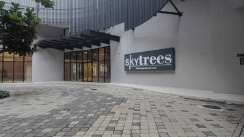 Skytrees Pangsapuri Servis offers a sleek, modern entrance with a glass door.
