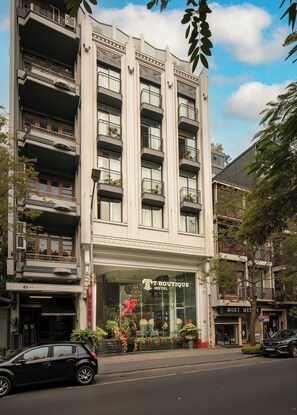 A multi-story hotel with a modern facade, large windows, and balconies. - T Boutique Hotel (Hanoi)