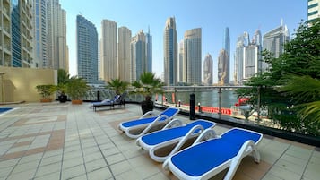 Outdoor pool, open 10:00 AM to 6:00 PM, pool umbrellas, pool loungers