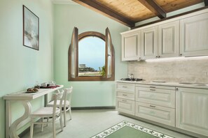 Junior Suite | Living area | 24-inch flat-screen TV with cable channels - Residence with private beach in Bosa Marina (Bosa)