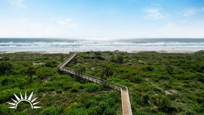 A coastal path leading to a beach with a wooden boardwalk and dense greenery. - Colony Reef Club 1203 - 3 Bedroom Oceanfront, 2nd floor with elevator access (St. Augustine Beach)