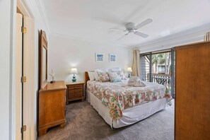 A bedroom with a bed, nightstands, a ceiling fan, and a view through a window. - Fresh & Modern Villa by the Sea Beach Club Getaway (Hilton Head Island)