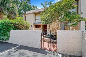 A residential building with a gated entrance, numbered 40, and a small porch area. - Fresh & Modern Villa by the Sea Beach Club Getaway (Hilton Head Island)