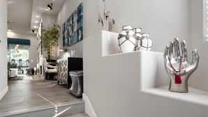 A modern interior with a staircase, a decorative hand sculpture, and a wall-mounted plant. - Zen Den Scottsdale: 2 King Suites Heated pool/Spa/Grill steps away (Scottsdale)