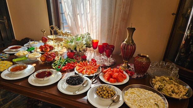 A table set with various dishes, glasses, and a decorative centerpiece. - Lost town Inn Hotel (Antalya)
