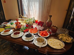 A table set with various dishes, glasses, and a decorative centerpiece. - Lost town Inn Hotel (Antalya)