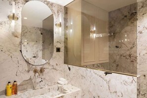 A modern bathroom with a marble sink, a large mirror, and a glass-enclosed shower. - A Splendid 2-BR/2BA with Services in Opéra (Paris)