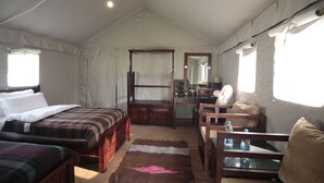 A tented accommodation room with two wooden beds, a desk, a chair, and a mirror. - KUMBH CAMP OM (Karchana)