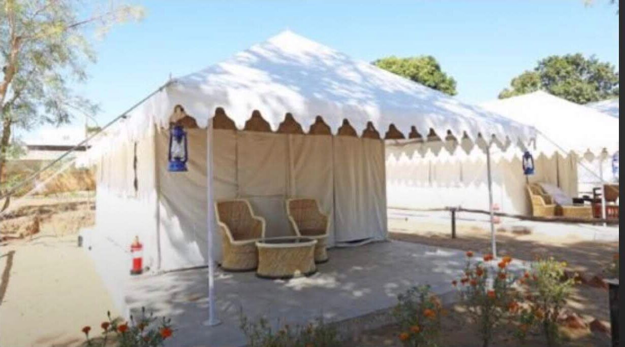 A tent with a covered seating area and a small table.