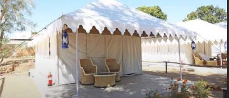 A tent with a covered seating area and a small table.
