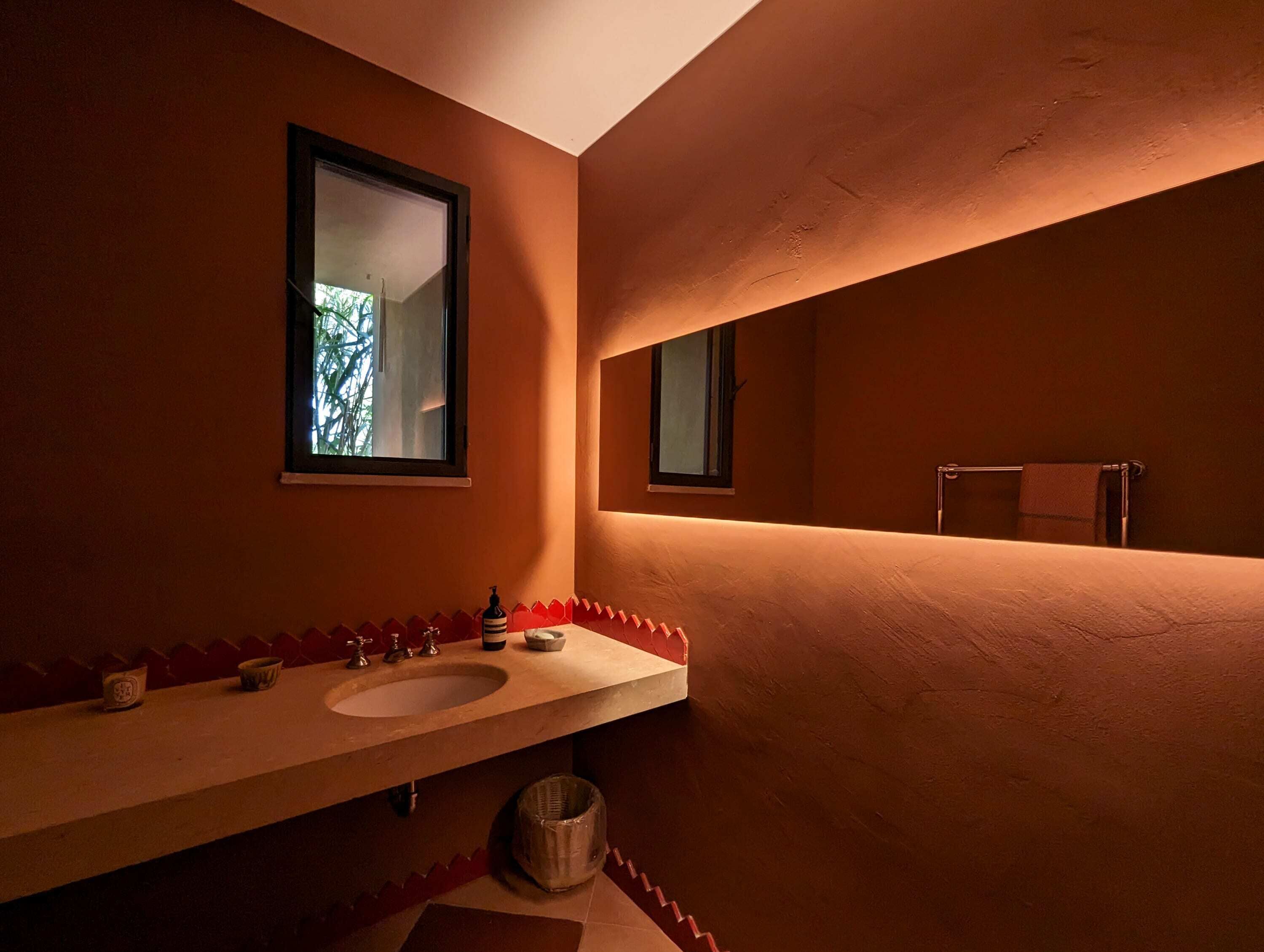 A bathroom with two sinks, a mirror, and a window.