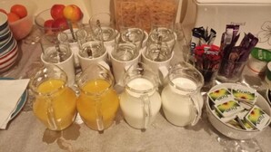 A breakfast buffet with various food items and beverages. - Knowesgate Hotel (Newcastle-upon-Tyne)