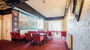 A conference room with red chairs and a large screen displaying Hogwarts Castle. - Knowesgate Hotel (Newcastle-upon-Tyne)