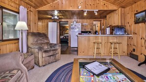 A cozy cabin interior with a living area, a kitchen, and a dining space. - Estrold's Resort- Driftwood Cabin (St.Germain)