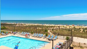 A swimming pool with lounge chairs and a view of the beach. - Oceanfront Building With Great Ocean and Bay Views (OCEAN OCEAN CITY)