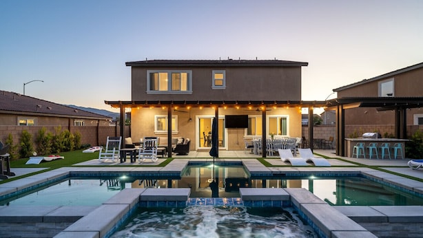 A modern house with a swimming pool, outdoor seating, and a covered patio area. - Entertainer`s Paradise | Luxe Pool + Game Room (Coachella)