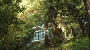 A building with multiple balconies surrounded by dense foliage. - Club Bellamare Beach (Marmaris)