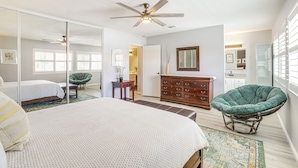 A bedroom with a bed, a green chair, a dresser, and a ceiling fan. - Pool Access & Mtn Views: Palm Springs Retreat! (Palm Springs)