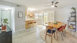 A modern kitchen with a dining area, wooden flooring, and a ceiling fan. - Pool Access & Mtn Views: Palm Springs Retreat! (Palm Springs)