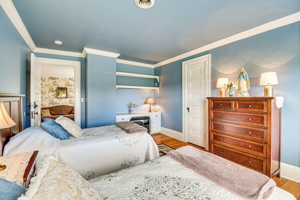 A bedroom with two beds, a dresser, a nightstand, and a desk. - Geneva Vacation Rental w/ Vineyard & Lake Views! (Geneva)