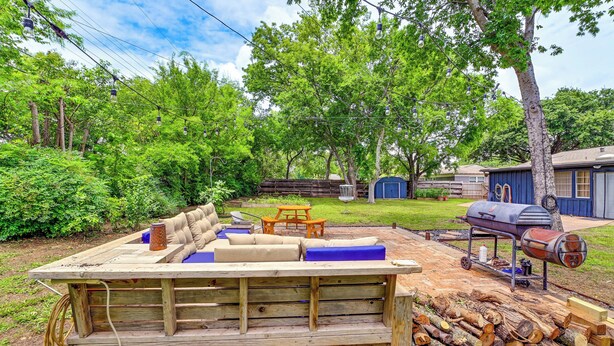 A wooden deck with a sofa, a grill, and a table. - Large Yard & Fire Pit! Home 13 Mi to At&t Stadium (Fort Worth)