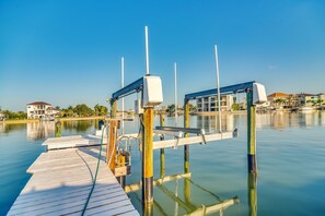 A wooden dock extending into calm water with a clear sky above. - Bayfront St Petersburg Home w/ Hot Tub & Dock! (St. Petersburg)